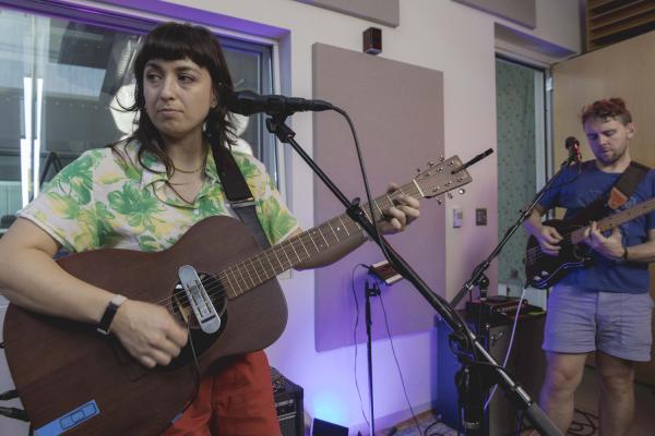 Elizabeth from The Beths looking off camera while performing Straight Line Was a Lie